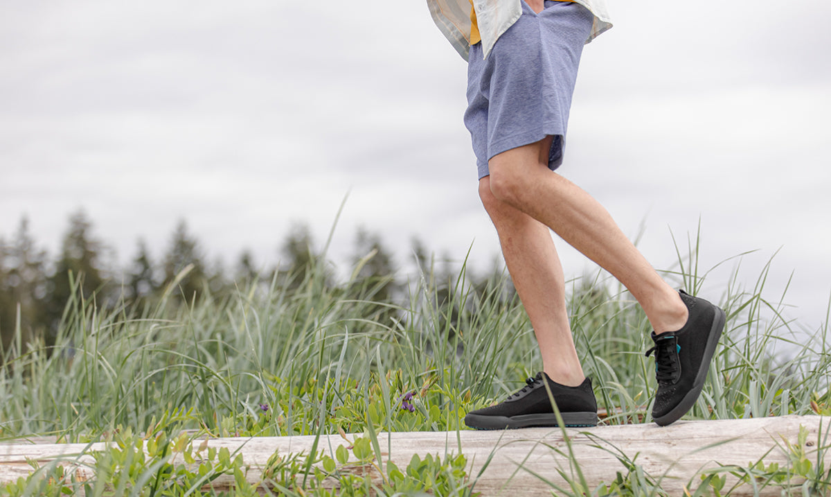 Sitting in grass with Vessi Weekend Sneakers