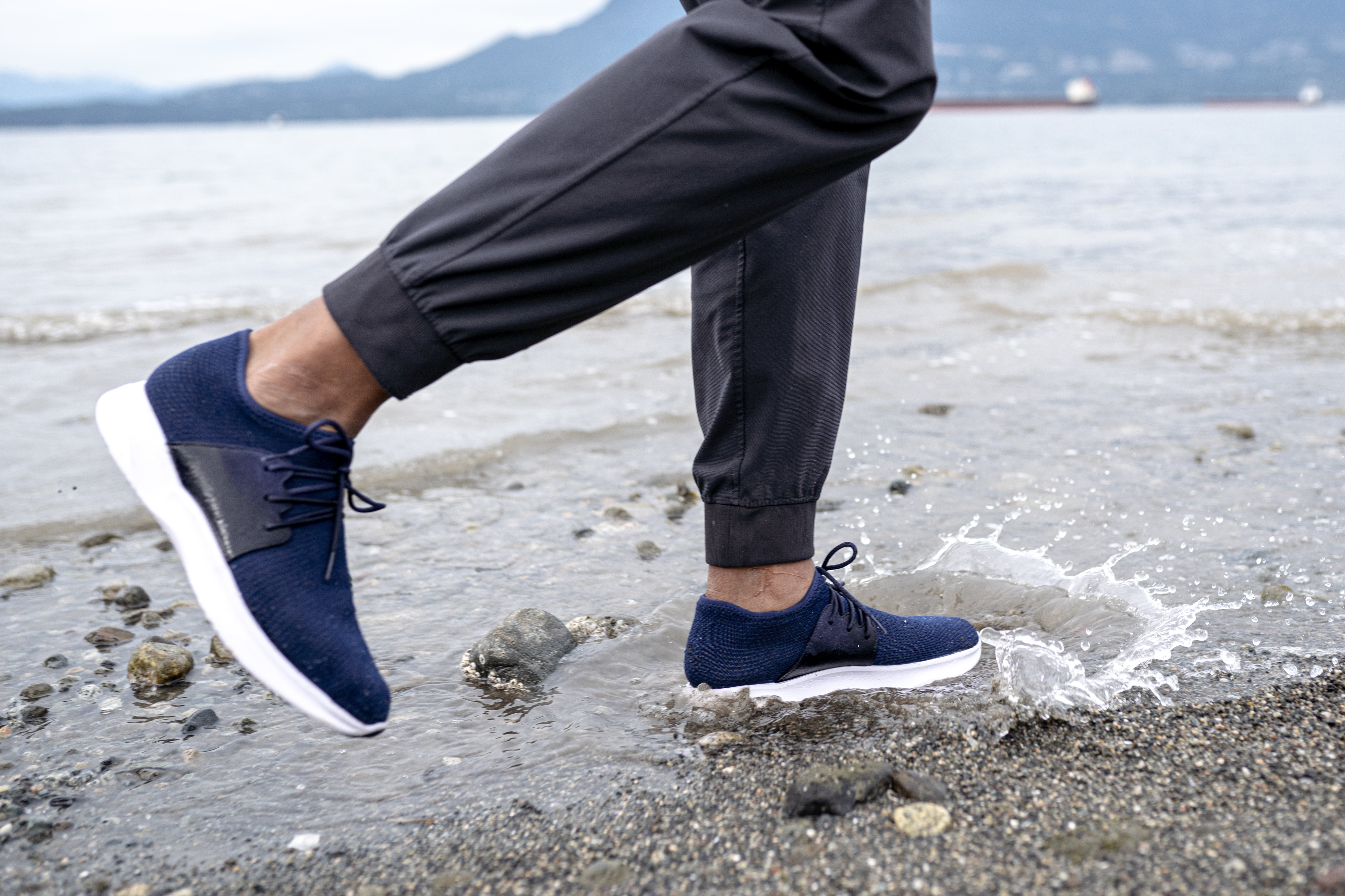 Man at the beach wearing Vessi Everyday Waterproof Shoes